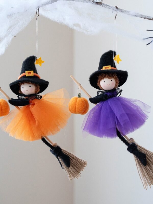 Halloween Broom Girl Angel Pendant in orange and purple silk cloth hanging on a front door