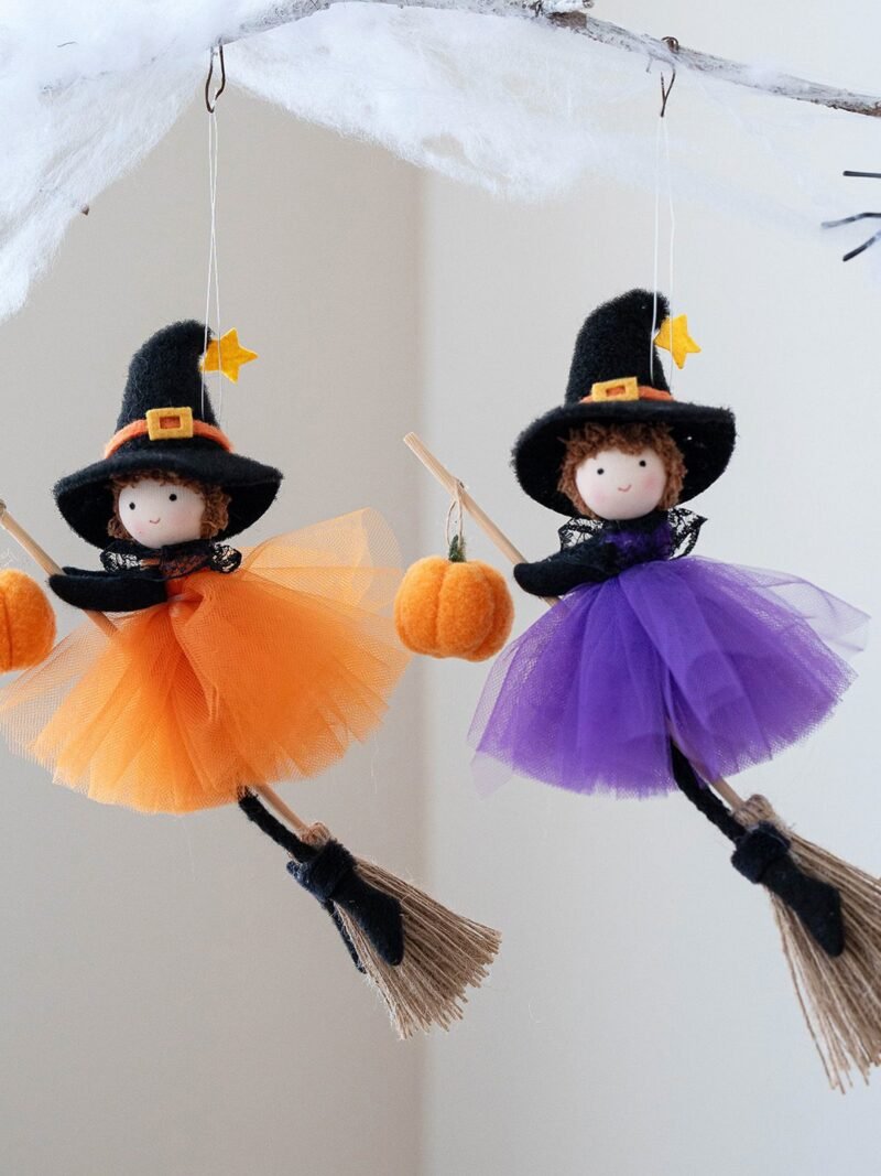 Halloween Broom Girl Angel Pendant in orange and purple silk cloth hanging on a front door